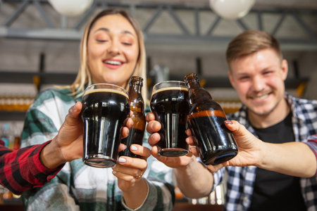 Group of friends watching sport match together. Emotional fans cheering for favourite team, watching on exciting game. Concept of friendship, leisure activity, emotionsの写真素材