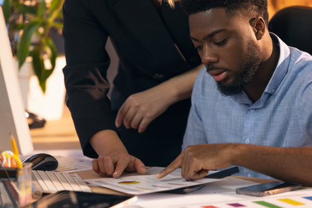Colleagues working together in modern office using devices and gadgets during creative meetingの写真素材