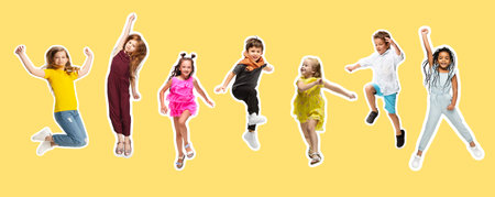 Group of elementary school kids or pupils jumping in colorful casual clothes on yellow background. Collage.の写真素材