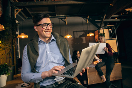 Man working in modern office using devices and gadgets during creative meeting