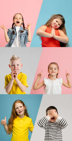 Art collage made of portraits of little and happy kids isolated on multicolored studio background. Human emotions, facial expression conceptの写真素材