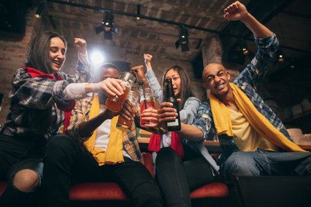 Group of friends watching sport match together. Concept of friendship, leisure activity, emotions