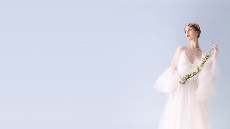 Young woman in art action isolated on white background. Retro style, comparison of eras concept.の写真素材
