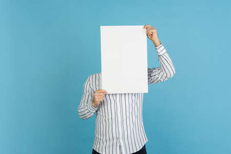 Young mans portrait on blue studio background. Concept of human emotions, facial expression, youth, sales, ad.の写真素材