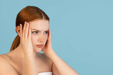 Close-up Caucasian womans portrait isolated over blue studio background with copyspace for ad. Concept of beauty, health.の写真素材