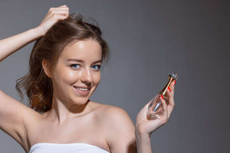 Portrait of young female fashion model isolated on grey studio background. Beautiful caucasian woman with well-kept skin.の写真素材