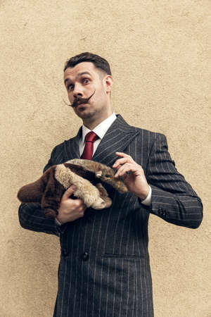 Portrait of young man in the image of greatest painter, artist isolated on light background. Retro...
