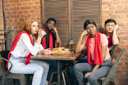 Group of friends watching sport match together. Concept of friendship, leisure activity, emotions