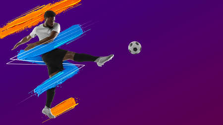 Art collage. Young man, soccer footbal player training isolated in neon light on purple background. Watercolor paints. Concept of sport, game, action.の写真素材