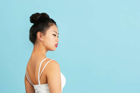Asian young womans portrait isolated on color studio background with copyspace for ad.