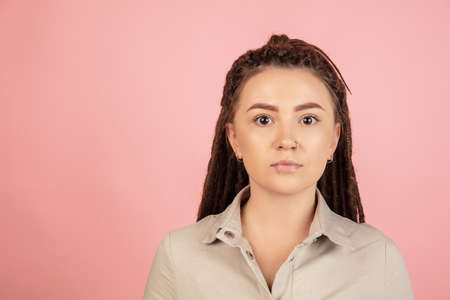 Caucasian young womans portrait isolated on pink studio background with copyspace for ad.