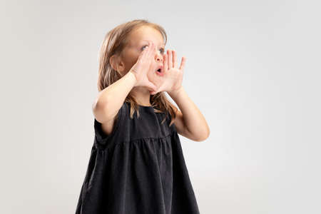 Caucasian girl isolated on white studio background. Copyspace. Childhood, education, emotions conceptの写真素材