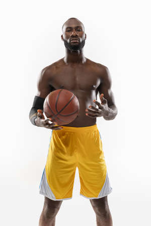 one african man basketball player holding ball in silhouette isolated white backgroundの写真素材
