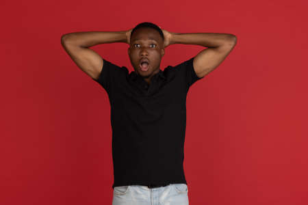 Wow. Beautiful male half-length front portrait isolated on studio backgroud. Young emotional...