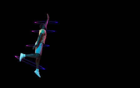 African mans portrait on black studio background in mixed neon light. Stylish sport outfit. Concept...