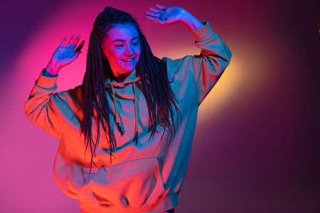 Young womans portrait on gradient colors studio background in neon. Concept of human emotions.の写真素材