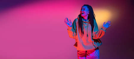 Young womans portrait on gradient colors studio background in neon. Concept of human emotions.