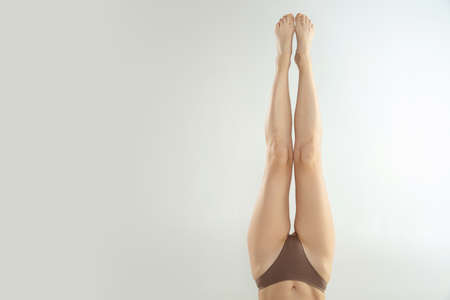 Beautiful female legs isolated on white background. Beauty, cosmetics, spa, depilation, treatment and fitness concept. Fit and sportive, sensual body with well-kept skin in underwear.の写真素材