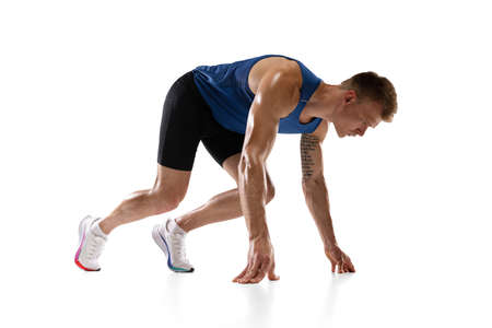 Caucasian professional male athlete, runner training isolated on white studio background. Muscular, sportive man. Concept of action, motion, youth, healthy lifestyle. Copyspace for ad.の写真素材