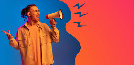 Young handsome man isolated over blue orange background in neon light. Concept of beauty, fashion,ad. Flyerの写真素材