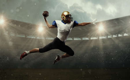 Young man american football player at stadium in motion. Action, activity, sportlife concept. Flyer for ad, design.の写真素材