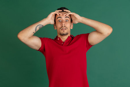Caucasian mans portrait isolated over green studio background with copyspaceの写真素材