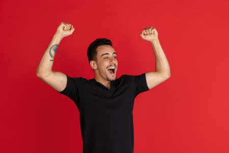 I won. Winning success happy man celebrating being a winner. Dynamic image of Caucasian male model on studio background.の写真素材