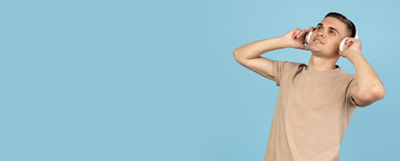 Portrait of young Caucasian man posing isolated over blue studio background with copyspace for ad....