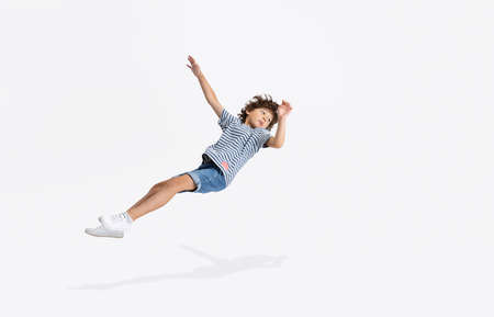 Portrait of Caucasian preschool boy isolated over white studio background. Copyspace. Childhood,...
