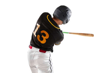 Baseball player, pitcher in a black white sports uniform practicing isolated on a white studio...