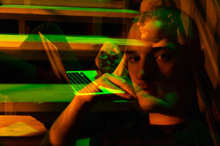 Cinematic portrait of handsome young man in neon lighted room, stylish male model indoors