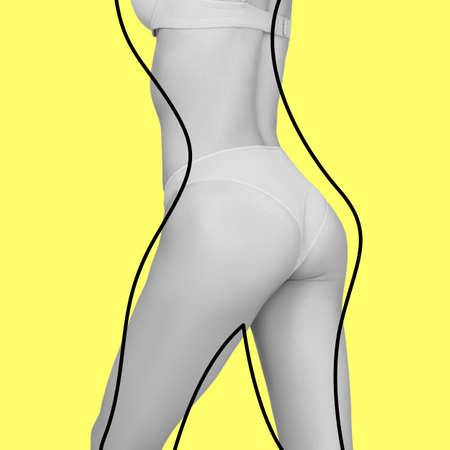 Slim female body with lifting up lines isolated on yellow background. Concept of bodycare, cosmetics, skincare, correction surgery, beautyの写真素材