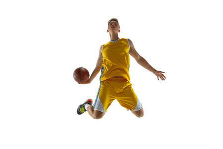 Full length portrait of a basketball player with a ball isolated on white studio background. Advertising concept. Fit Caucasian athlete jumping with ball.の写真素材