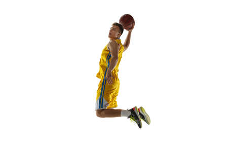 In action. One young man, basketball player with a ball training isolated on white studio...