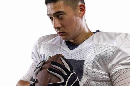 Close-up young American football player, athlete posing isolated on white studio background. Concept of professional sport, championship, competition.の写真素材