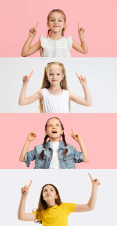 Art collage made of portraits of little and happy children isolated on white and pink studio background. Human emotions, facial expression conceptの写真素材