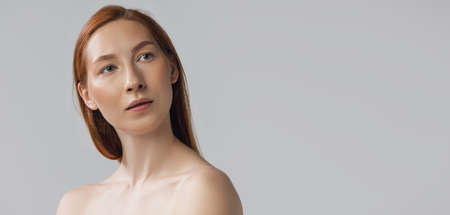 Close-up beautiful redheaded woman in lingerie posing isolated over gray studio back ground. Fitness, diet, sports, natural beauty and aesthetic cosmetology concept. Flyerの写真素材