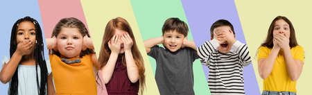 Collage made of portraits of little cute kids, boys and girls isolated on multicolored studio background. Human emotions, facial expression, childhood conceptの写真素材