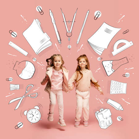 Artwork with happy little children, cute girls going to go to school among drawned school supplies, notes, pen, brush on light background.の写真素材