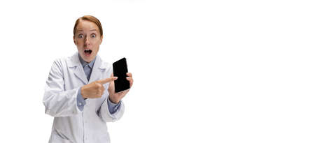 Using phone. Portrait of female doctor, therapeutic or medical advisor showing smartphone screen....