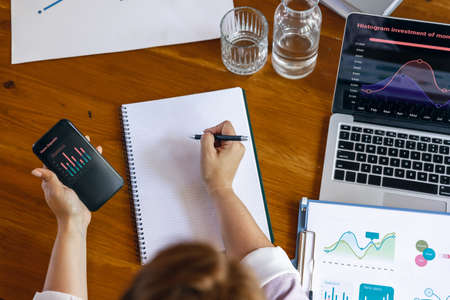 Close up female hands during working office day. Using laptop, modern gadgets. Remote working....