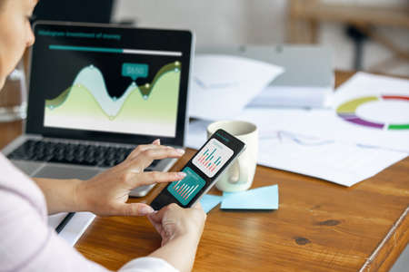 Young woman, manager working at office. Using laptop, modern gadgets. Remote working. Workplace at...