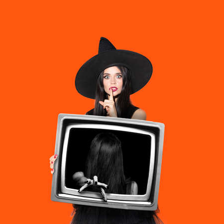 Contemporary art collage. Composition with young scary witch in retro tv set isolated on purple...