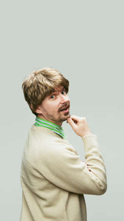 Caucasian mans portrait in retro style, fashion of 70s, 80s years isolated on gray studio background...