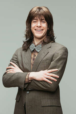 Caucasian mans portrait in retro style, fashion of 70s, 80s years isolated on gray studio background with copyspace for ad.の写真素材