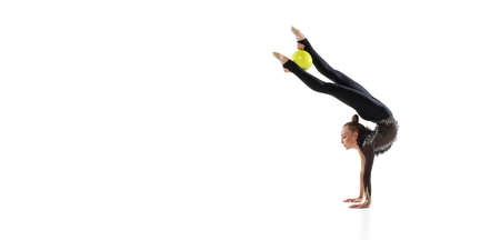 Flyer with of little sportive girl, rhythmic gymnastics artist isolated on white studio background. Concept of sport, action, aspiration, education, active lifestyleの写真素材