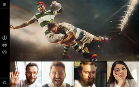 Young men and women watching rugby football game online, using video app. PC, laptop screen with...
