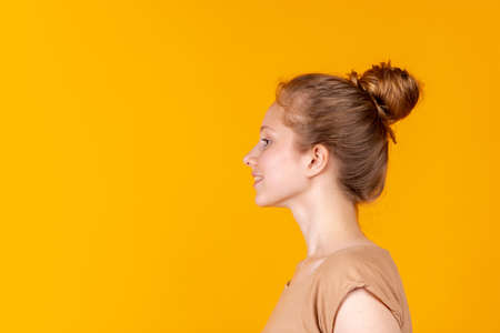 Portrait of young beautiful girl isolated on purple studio background. Concept of human emotions,...