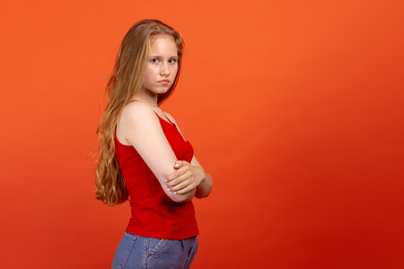 Portrait of young beautiful girl isolated on purple studio background. Concept of human emotions, facial expression, youth, sales, ad. Side viewの写真素材