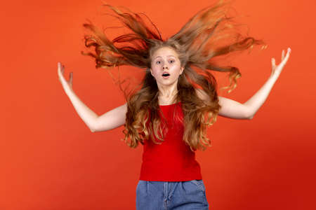 Horizontal portrait of young scared girl isolated on red studio background. Concept of human emotions, facial expression, youth, sales, ad.の写真素材
